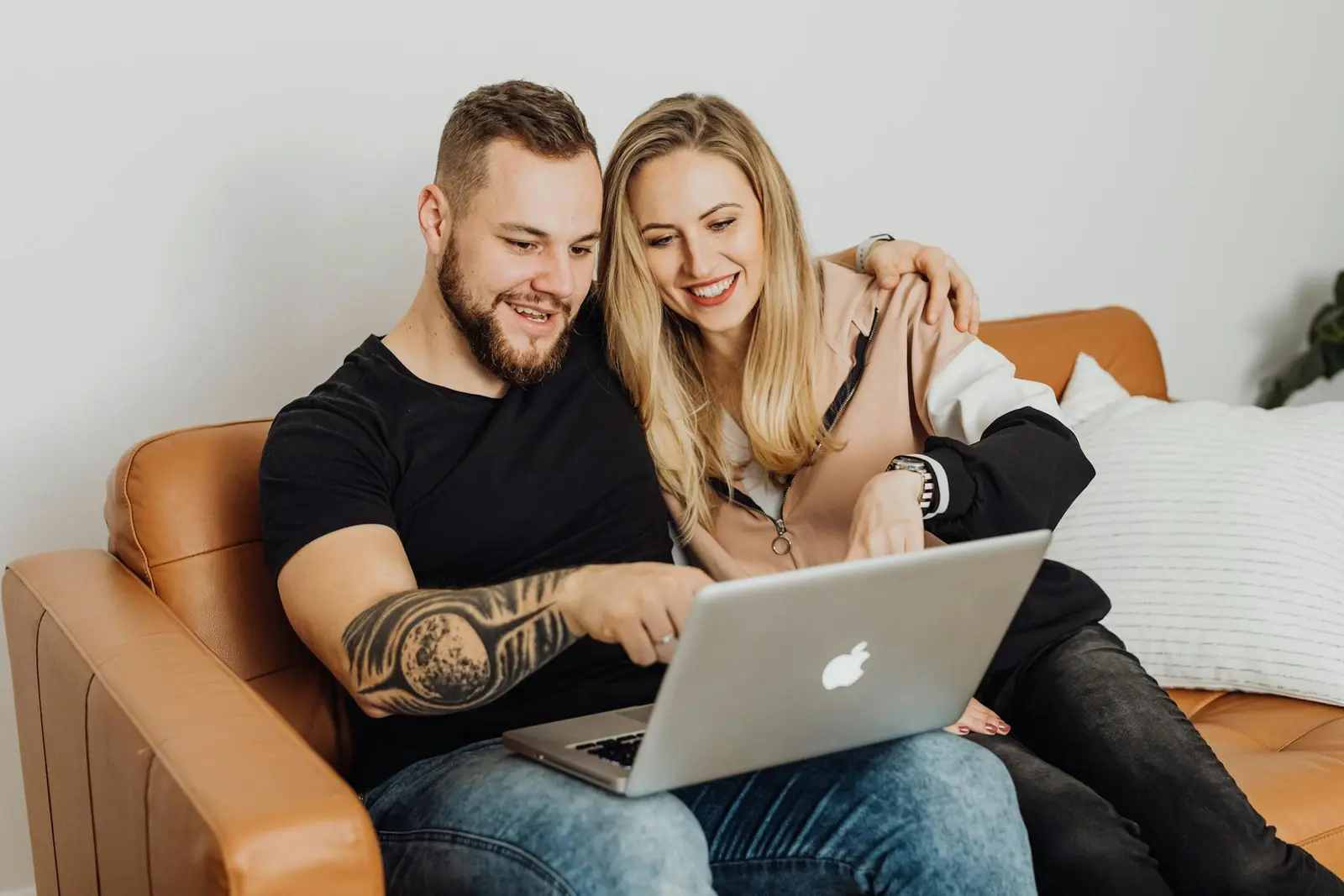 Couple looking at solar power options on laptop